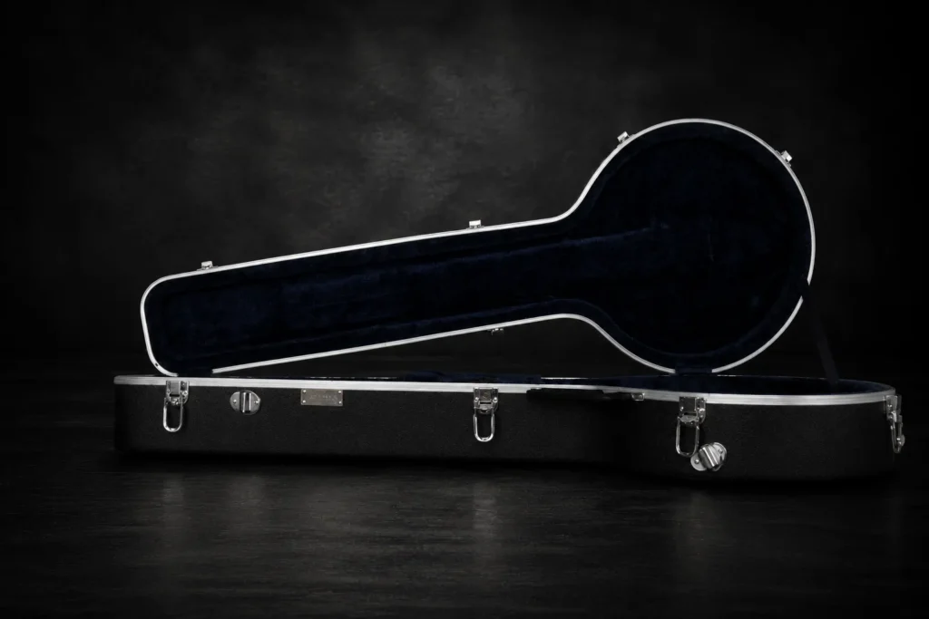 Nacho Bizness Custom black 5-string banjo case open on a dark studio background, with deep navy padded interior, silver trim, and chrome hardware.